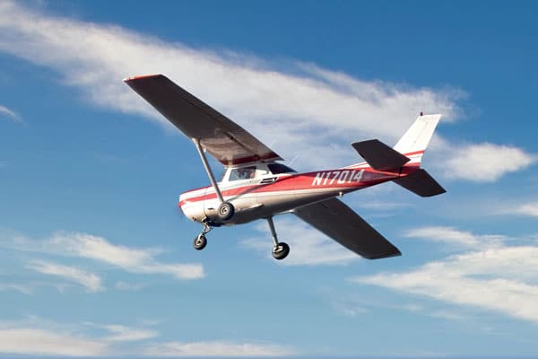 A Cessna airplane flying in a blue sky
