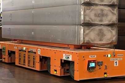 An automated guided vehicle transporting large metal ingots