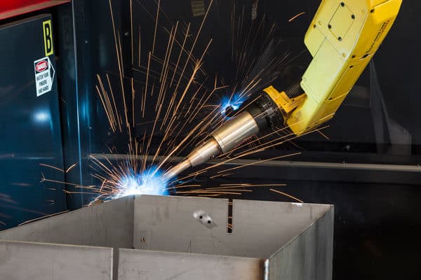 A robotic welder welding a metal part for the energy and power generation industry