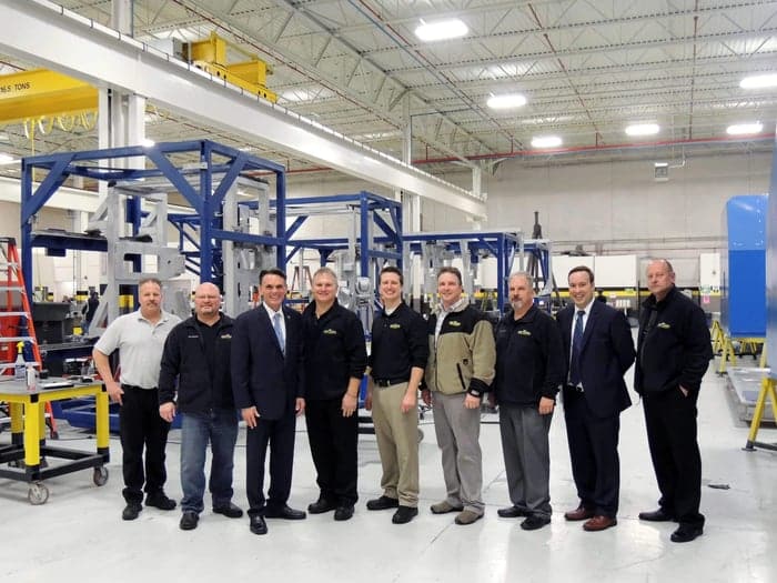 A group photo of the Baker Industries team with Mark Hackel, Macomb County Executive