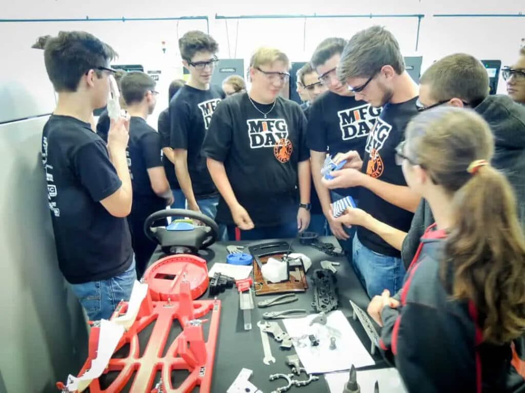 Students looking at 3D-printed parts, prototypes, and tooling at Baker Industries