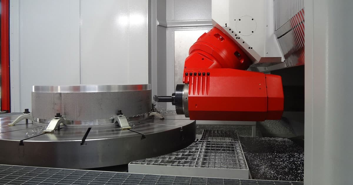 An EMCO MECOF Umill 1800 Universal Machining Center performing high-precision CNC turning operations on a large metal part