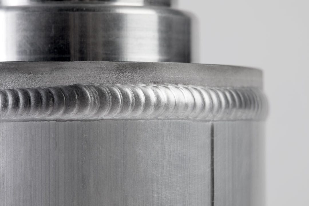 A close-up shot of weld beads on a round aluminum component