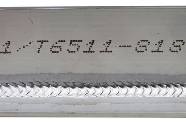 Weld beads (stacked dimes) on a metal part for the rail and ground transportation industry