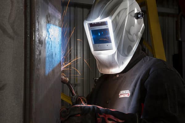 A fabricator welds a large steel part or tooling for rolling stock manufacturing