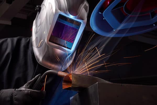 A fabricator welding a part