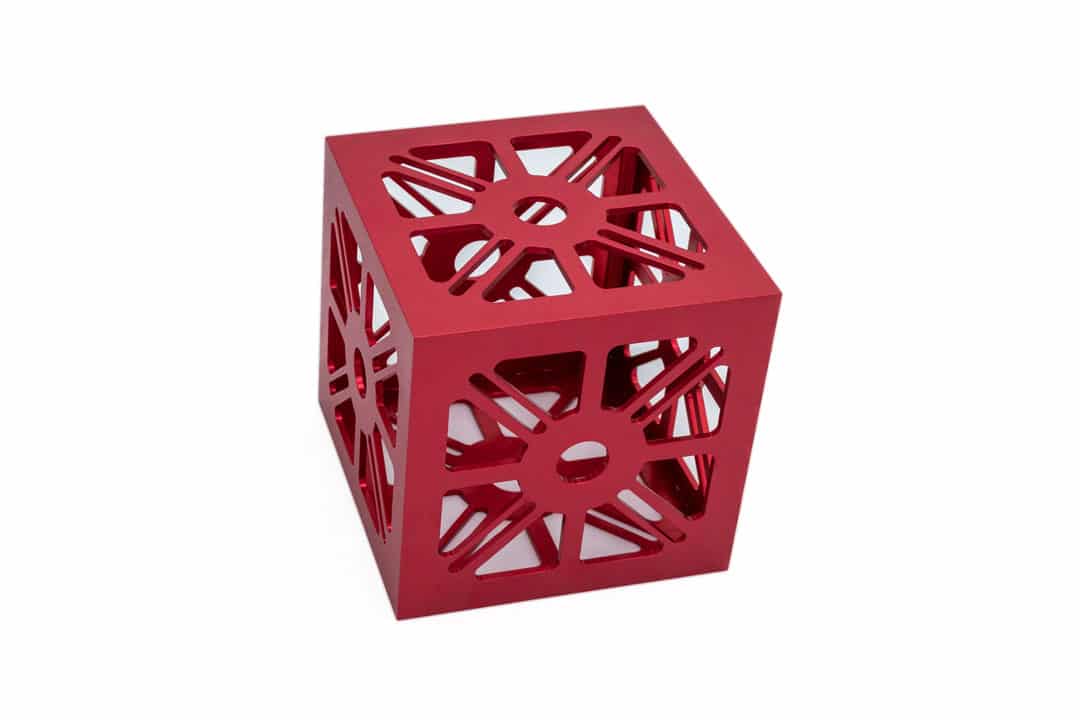 CNC-machined aluminum CubeSat bus with a red anodized finish